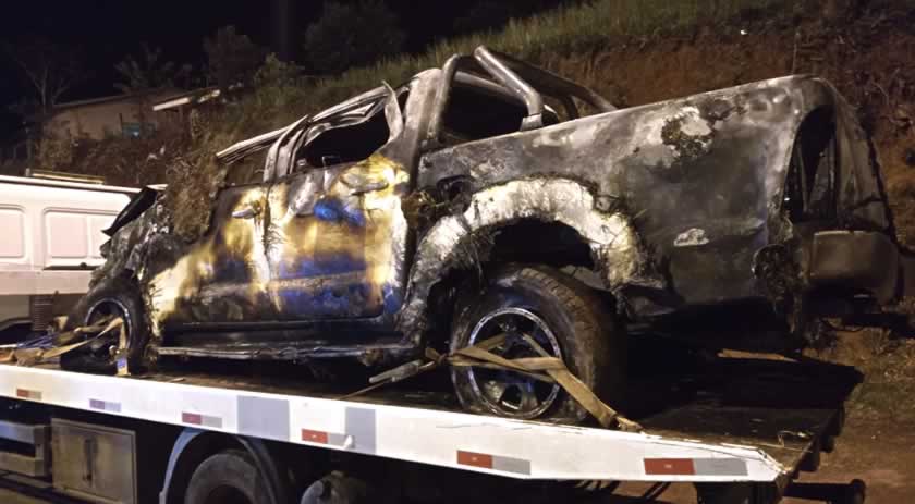 Homens conseguem sair de caminhonete após veículo capotar e pegar fogo