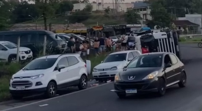 Carreta com placas de Descanso tomba e população saqueia carga de leite na BR-470